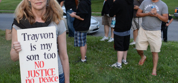 Connellly Stewart of Frederick holds the sign she brought to the march for Trayvon Martin as people gathered in a field off Burke St. in Frederick, Md. Tuesday night July 16, 2013. About 200 marchers took to the streets of downtown Frederick. (AP Photo/The Frederick News-Post,Sam Yu)