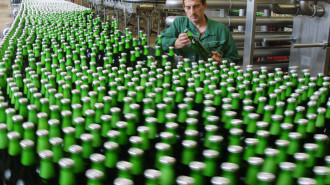 Worker Olaf Wehrbrink checks a bottle of Beck's beer in the Beck brewery bottling plant in Bremen, northwest Germany, in this Aug. 8, 2001 file picture. German beer sales rose slightly in the first half of 2004 as exports grew, but consumption at home declined, according to statistic reports released, Wednesday, July 28, 2004. (AP Photo/Joerg Sarbach)