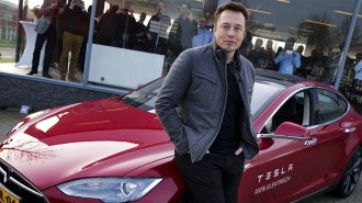 Elon Musk, co-founder and CEO of Tesla, poses with a model of his own car brand on 31 January 2014. Photo: dpa
